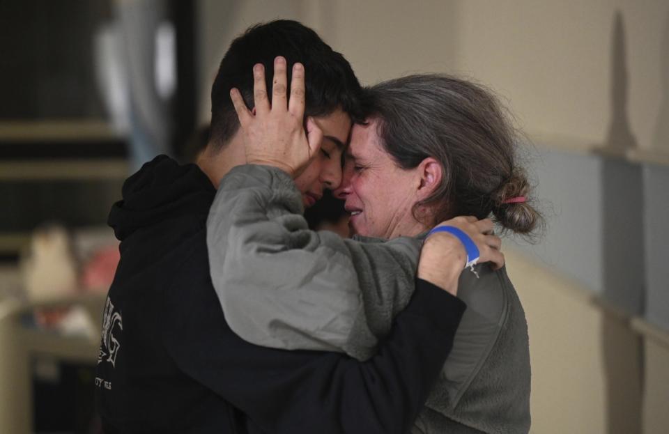 This handout photo provided by Haim Zach/GPO shows Sharon Hertzman, right, hugging a relative as they reunite at Sheba Medical Center in Ramat Gan, Israel, Saturday Nov. 25, 2023. Sharon Hertzman and her daughter Noam, 12 years old, not pictured, were released by Hamas after being held as hostages in Gaza for 50 days. (Haim Zach/GPO/Handout via AP)