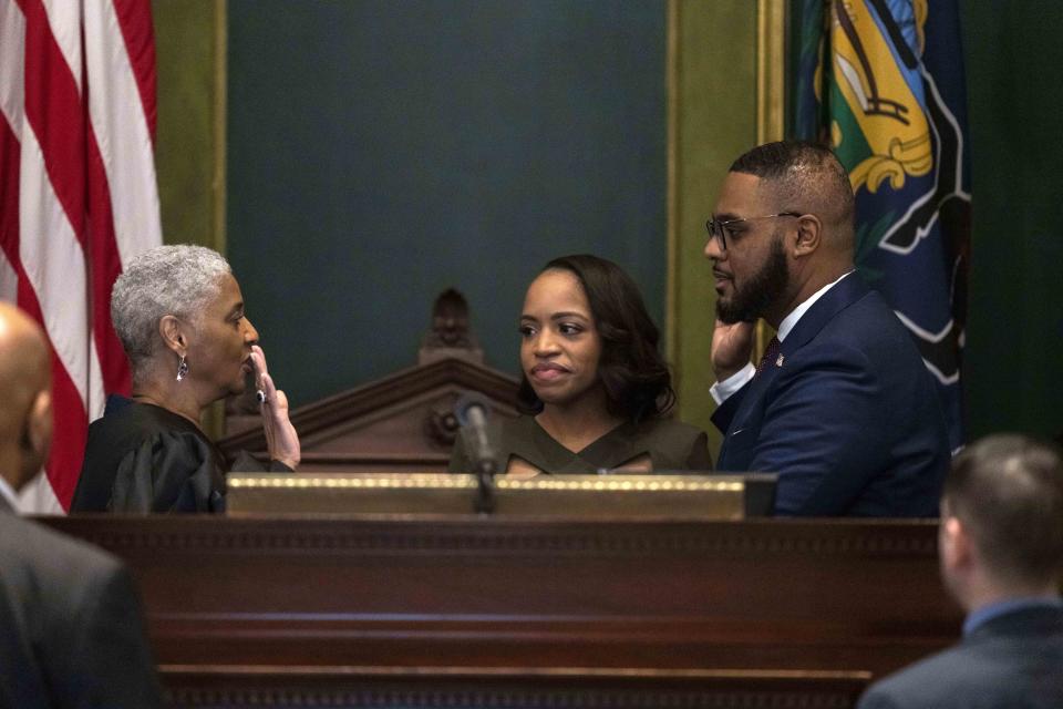 Austin Davis accompanied by his wife Blayre Holmes Davis takes the oath of office, administered by Allegheny County Judge Kim Berkeley Clark to become Pennsylvania's first Black lieutenant governor, during a ceremony Tuesday, Jan. 17, 2023, at the state Capitol in Harrisburg, Pa. (AP Photo/Matt Rourke)