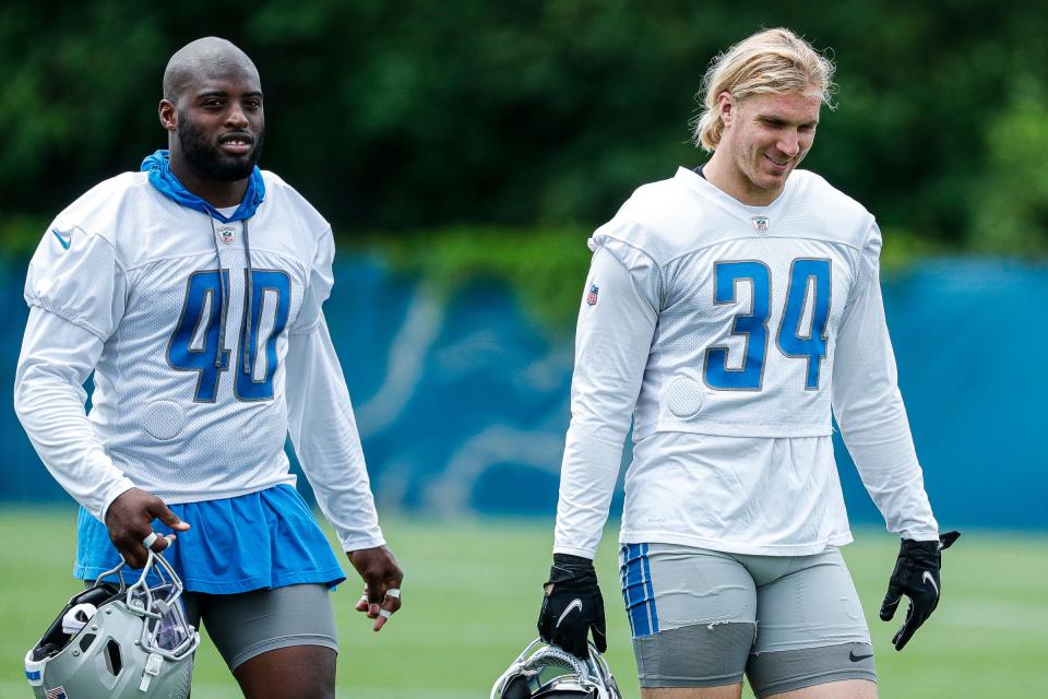 Lions linebacker Jarrad Davis, left, and linebacker Alex Anzalone walk off the field after practice during minicamp in Allen Park on Wednesday, June 8, 2022.