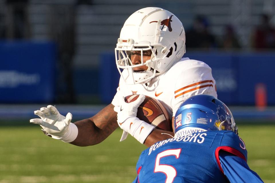 Savion Red carries the ball against Kansas last season. A versatile athlete who has moved from receiver to running back, Red could play a hybrid role for the Texas offense similar to what Deebo Samuel does for the San Francisco 49ers, UT coach Steve Sarkisian said.