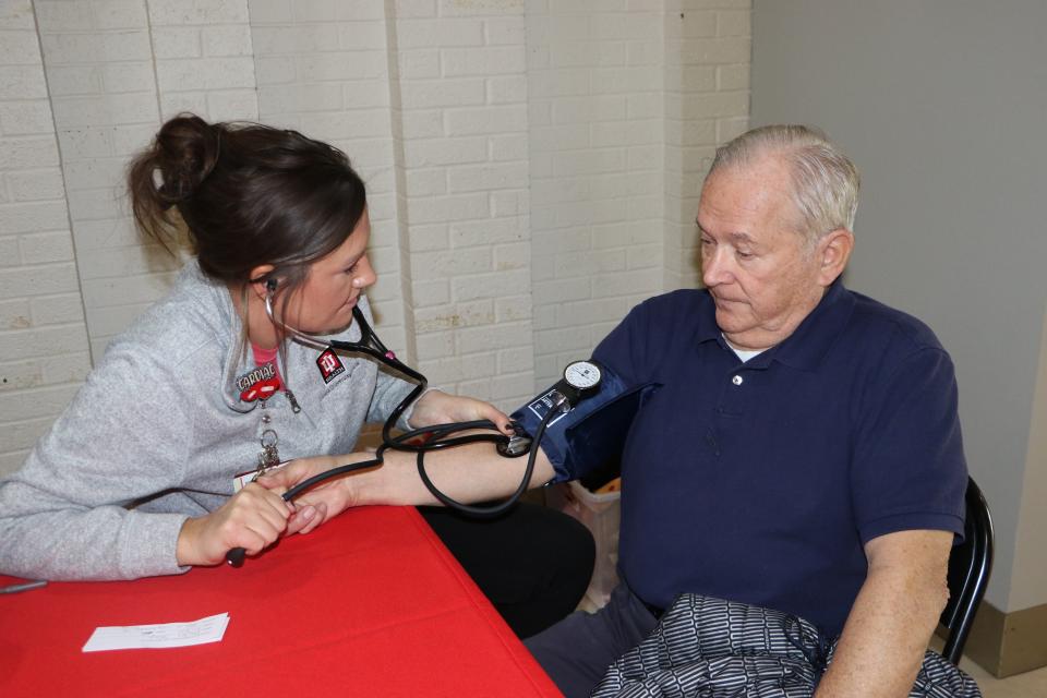Jack Sharpe gets his blood pressure checked by Erica Boggs, an IU Health Ball Memorial Hospital employee Feb. 23, 2023. Sharpe and his wife, Phyllis, walk in the Muncie Mall every day for their daily exercise.