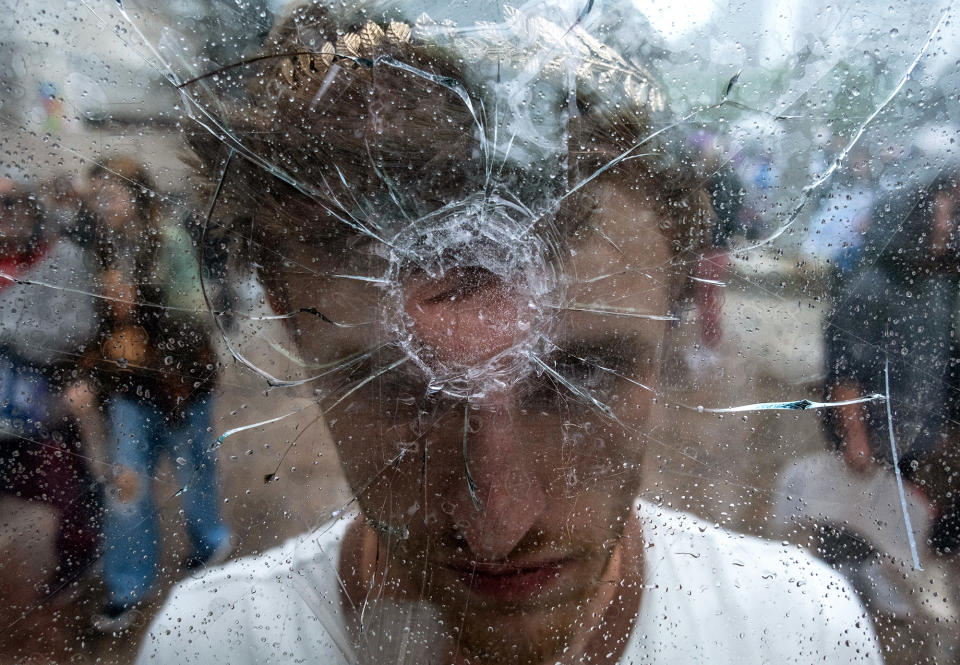 A protester holds a shattered window mimicking a gunshot to his forehead, as students from across Nashville walked out of schools and gathered at the Tennessee State Capitol to demand action for gun reform laws, on April 3, 2023.