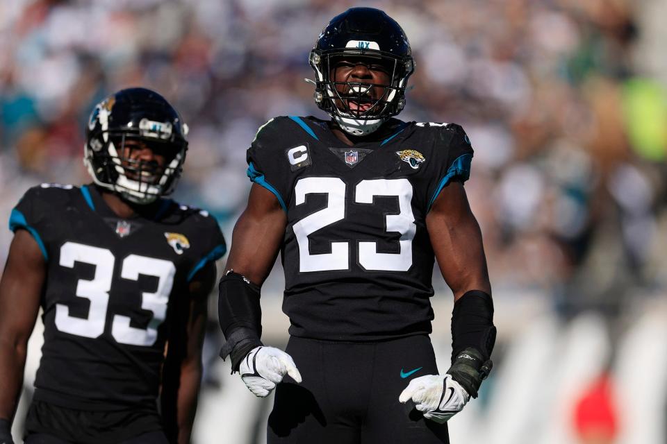 Jacksonville Jaguars linebacker Foyesade Oluokun (23) reacts to his third down stop as teammate linebacker Devin Lloyd (33) looks on during the second quarter of a regular season NFL football matchup Sunday, Dec. 18, 2022 at TIAA Bank Field in Jacksonville. The Jacksonville Jaguars edged the Dallas Cowboys 40-34 in overtime. 