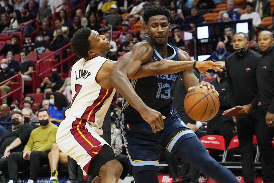 Memphis Grizzlies forward Jaren Jackson Jr. (13) drives to the basket as Miami Heat guard Kyle Lowry (7) defends during the first half of an NBA basketball game, Monday, Dec. 6, 2021, in Miami. (AP Photo/Marta Lavandier)