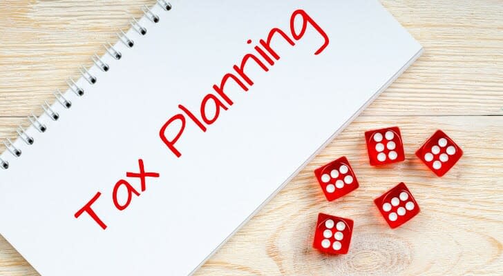 Tax planning notebook with some dice