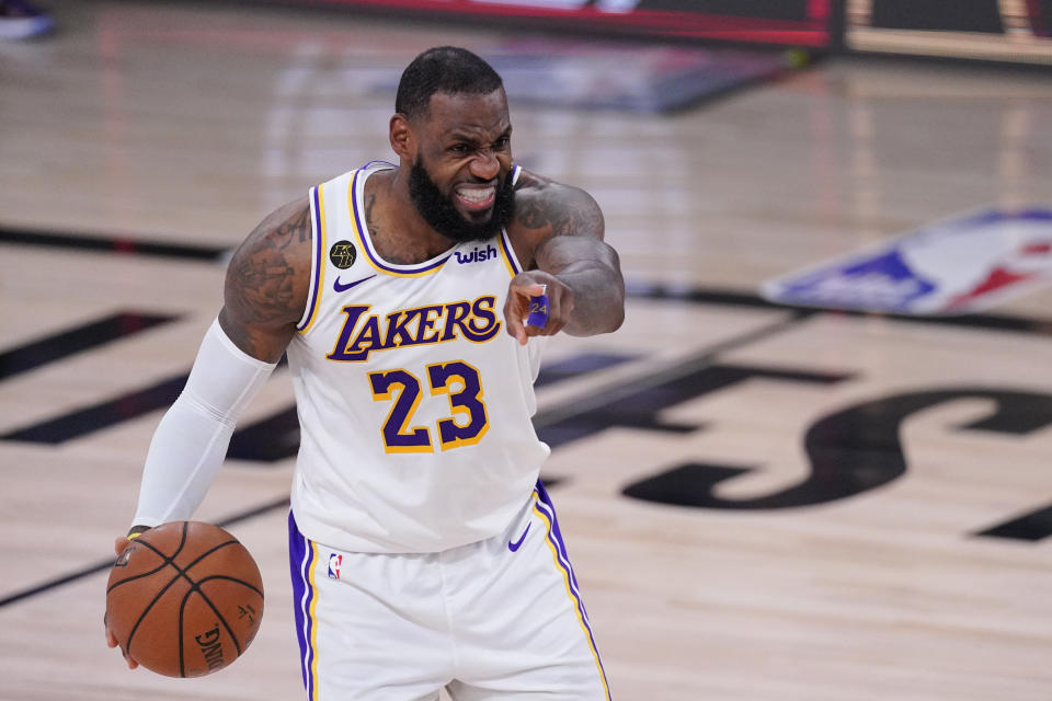 Los Angeles Lakers' LeBron James (23) directs the offense during the second half of an NBA conference semifinal playoff basketball game against the Houston Rockets Saturday, Sept. 12, 2020, in Lake Buena Vista, Fla. (AP Photo/Mark J. Terrill)