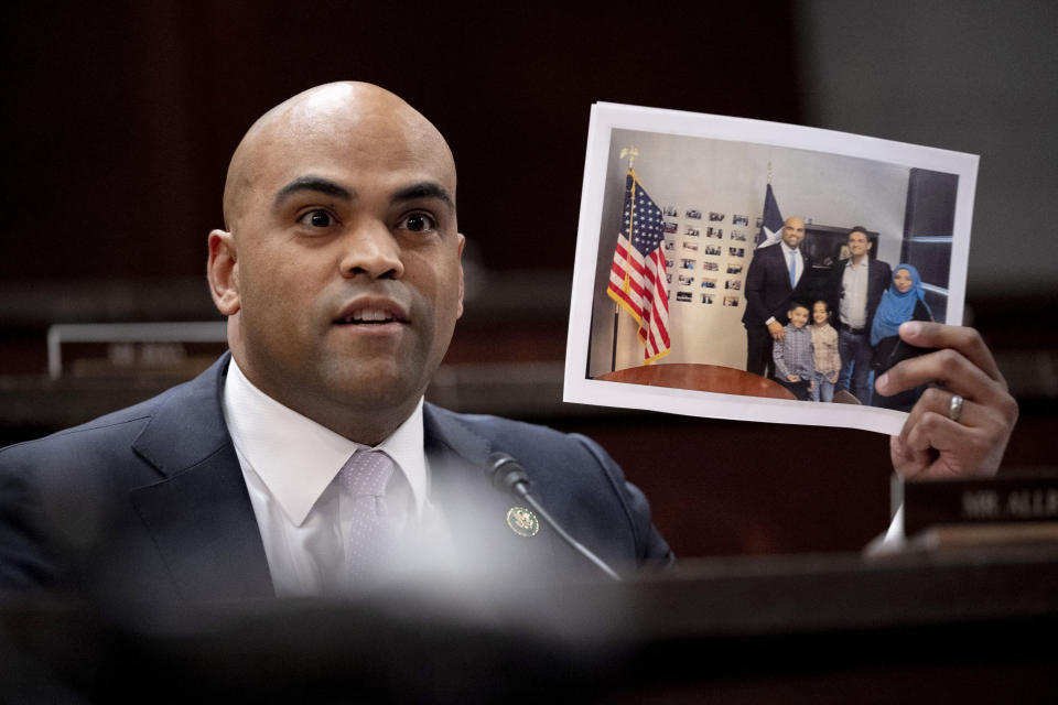 Rep. Colin Allred, D-Texas, holds up a photograph of a man evacuated out of Afghanistan as he speaks during a House Committee on Foreign Affairs hearing on the United States evacuation from Afghanistan on Capitol Hill in Washington, Wednesday, March 8, 2023. (AP Photo/Andrew Harnik)