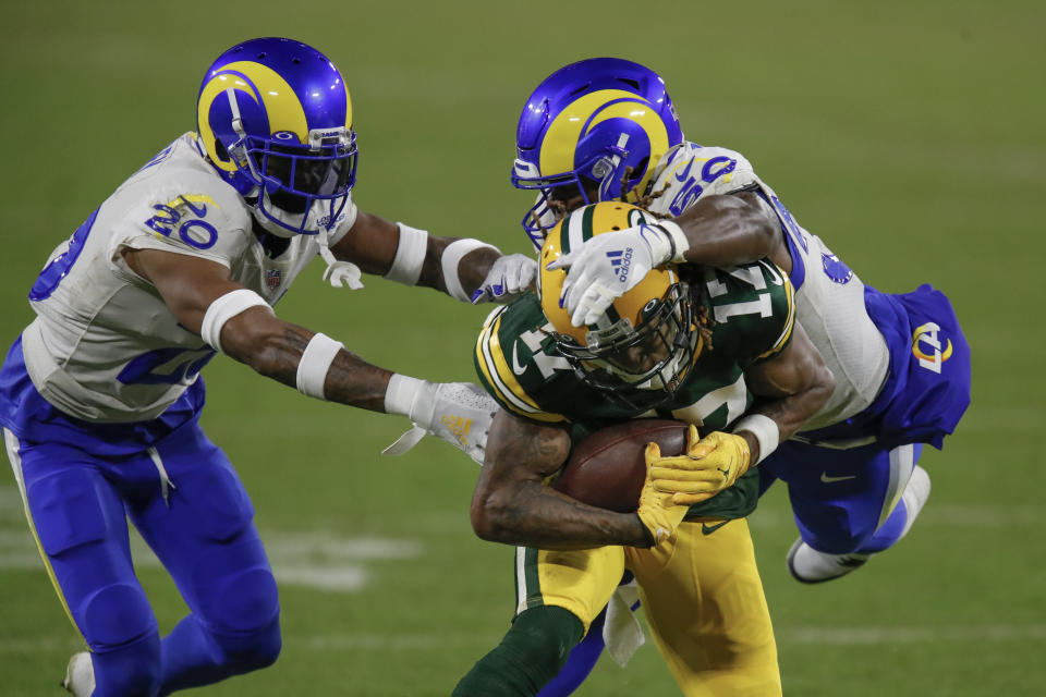 Los Angeles Rams' Samson Ebukam (50) and Rams' Jalen Ramsey stop Green Bay Packers' Davante Adams during an NFL divisional playoff football game Saturday, Jan. 16, 2021, in Green Bay, Wis. The Packers defeated the Rams 32-18 to advance to the NFC championship game. (AP Photo/Matt Ludtke)