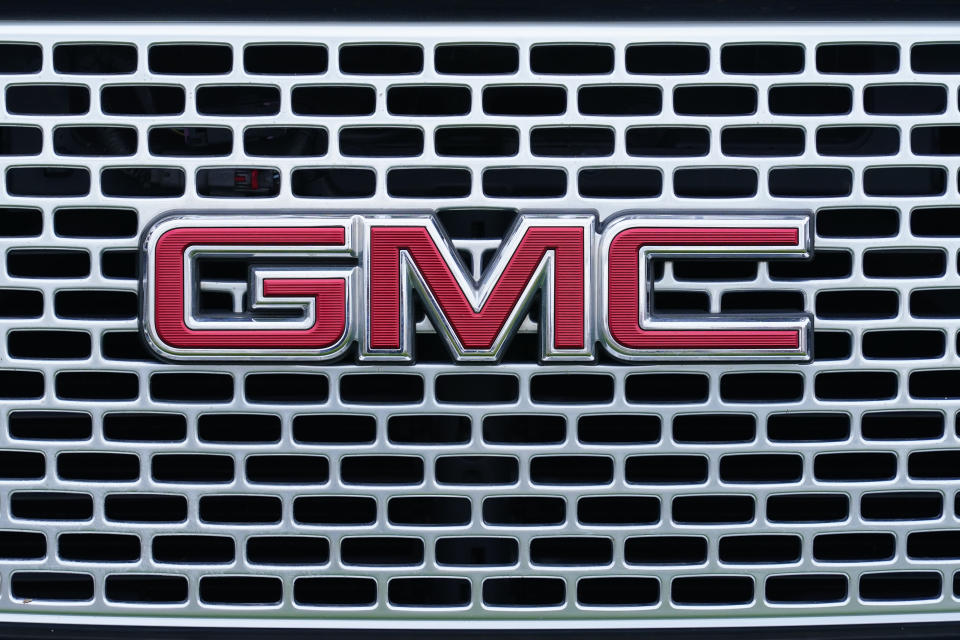 FILE - The GMC logo is displayed on the grill of a truck at a GMC dealership in Warminster, Pa., Tuesday, April 26, 2022. General Motors announced Friday, Jan. 20, 2023 it will spend more than $900 million to update four factories, with the bulk going to an engine plant in Flint, Mich., to build the next-generation V8 for big pickup trucks and SUVs. (AP Photo/Matt Rourke, File)