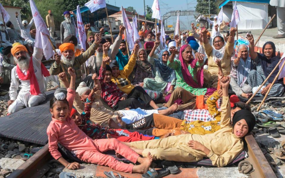 Farmers and their children protest the new bill - NARINDER NANU/AFP via Getty Images