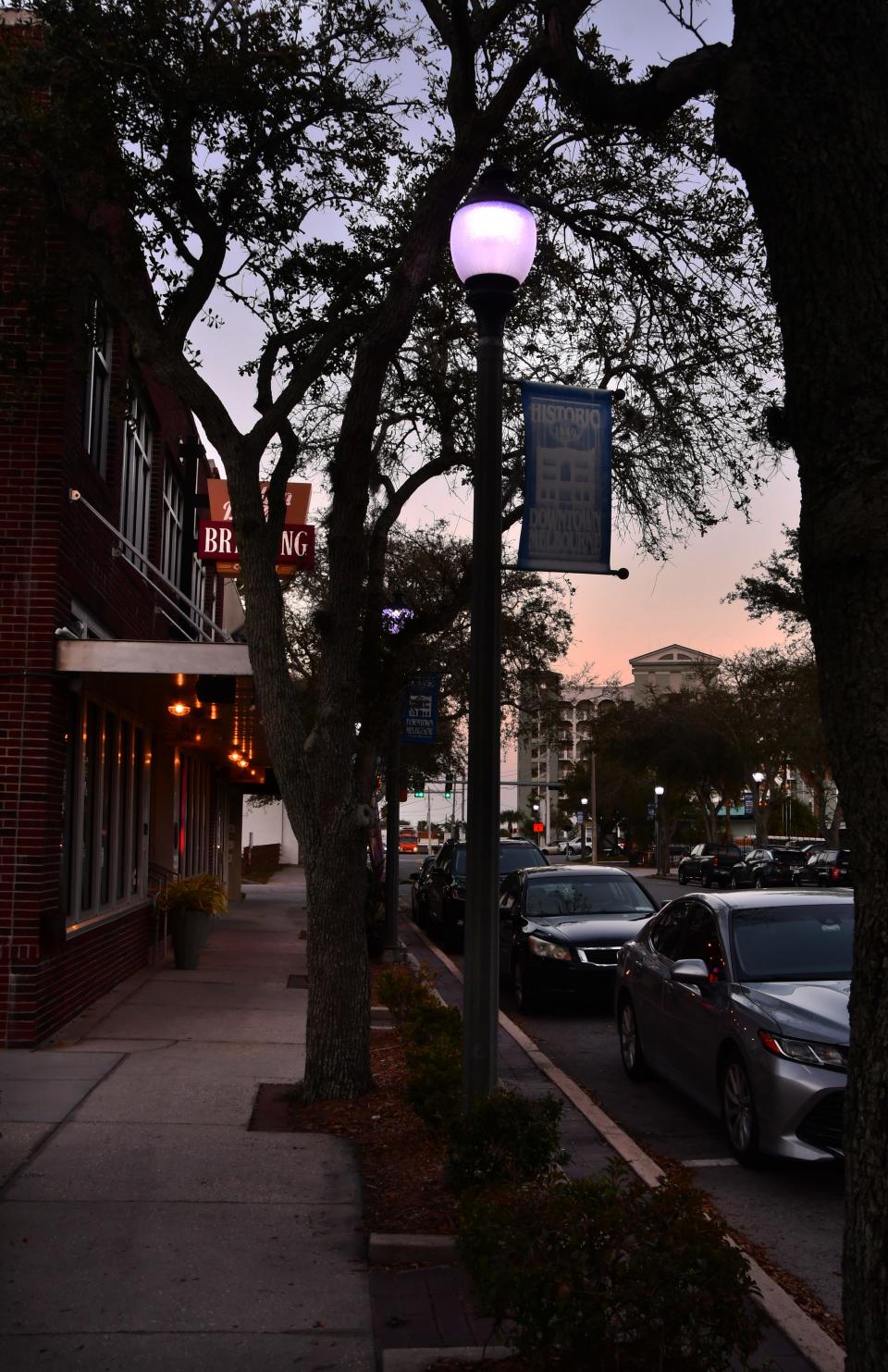 A street lamp is illuminated near sundown outside Hell 'n Blazes Brewing Co. in downtown Melbourne.