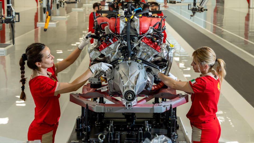 Ferrari technicians assembling a power train at Ferrari's new "E-building," where it plans to produce its first electric model.