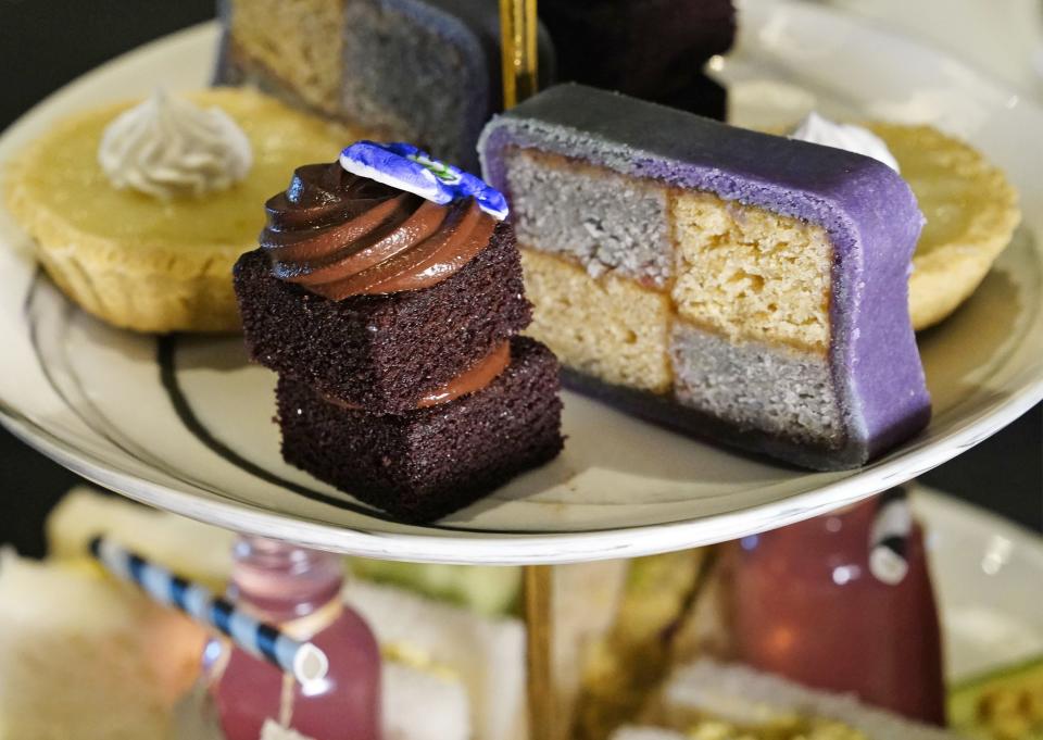 Wonderland Afternoon Tea Treats - Chocolate Espresso Cake, Almond Chess Board Cake, Lime Tart, Vanilla Shortbread, and Earl Grey Macaron at Drink Me Tea Room in Tempe, Ariz. on Nov. 18, 2021.