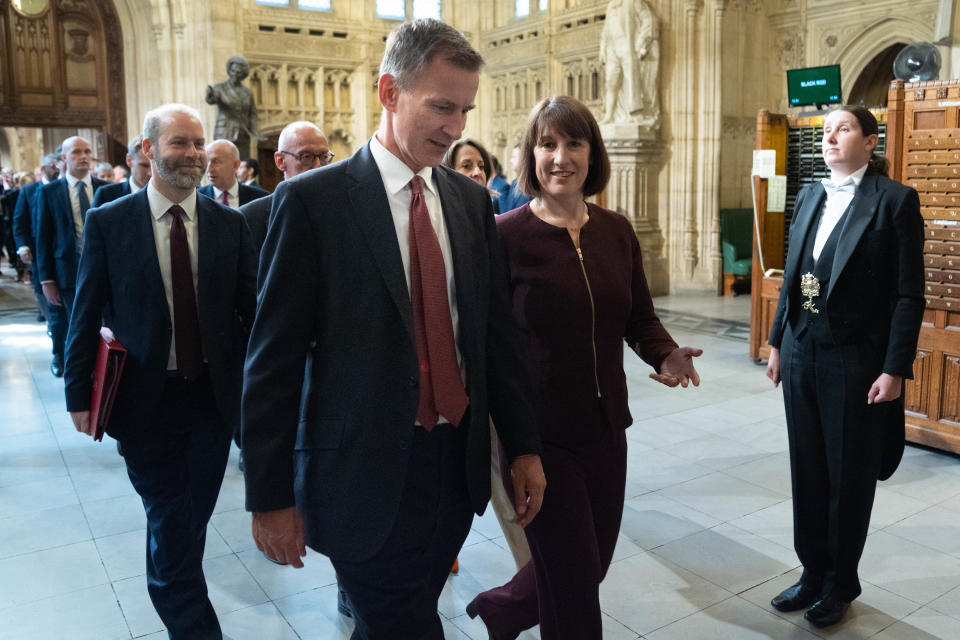 LONDON, ENGLAND - JULY 17: Chancellor of the Exchequer Rachel Reeves (R) and Shadow chancellor Jeremy Hunt walk through the Member's Lobby of the Houses of Parliament in London after hearing the King's Speech during the State Opening of Parliament, on July 17, 2024 in London, England. King Charles III delivers the King's Speech setting out the new Labour government's policies and proposed legislation for the coming parliamentary session. (Photo by Stefan Rousseau  - WPA Pool/Getty Images)