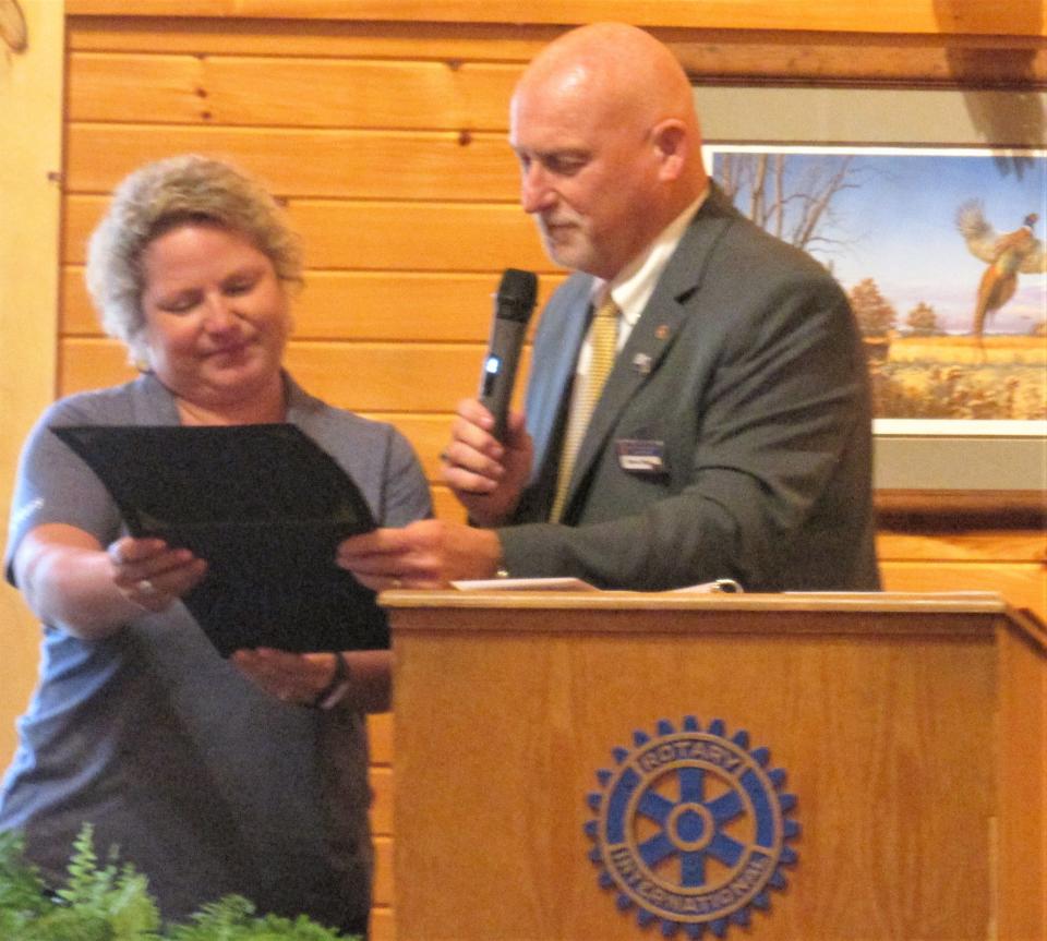 Rotary District Gov. Stephan Wilder presents a 100th anniversary certificate to Millersburg Rotary Club President Shasta Mast at a June 1 celebration.