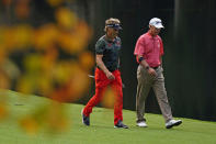 CORRECTS LARR MIZE, NOT SANDY LYLE: Bernhard Langer, left, of Germany, walks with Larry Mize on the 15th hole during a practice round for the Masters golf tournament Tuesday, Nov. 10, 2020, in Augusta, Ga. (AP Photo/Matt Slocum)