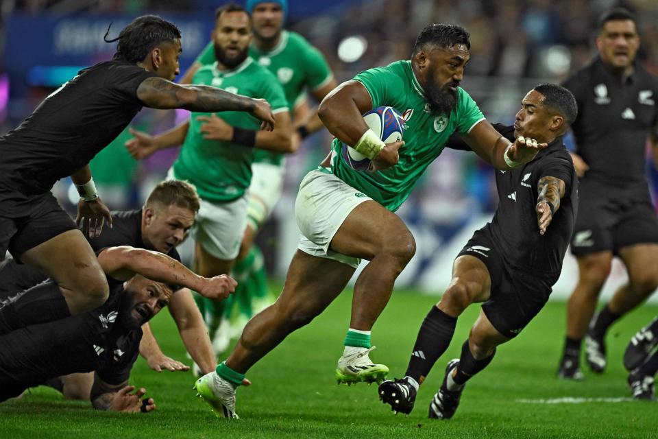 Bundee Aki barrels through the All Blacks’ defence to score (AFP via Getty Images)