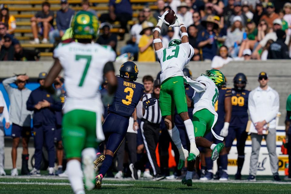 Oregon defensive back Bryan Addison (13) intercepts a pass against California during the first half of the game in Berkeley, Calif., on Oct. 29, 2022.