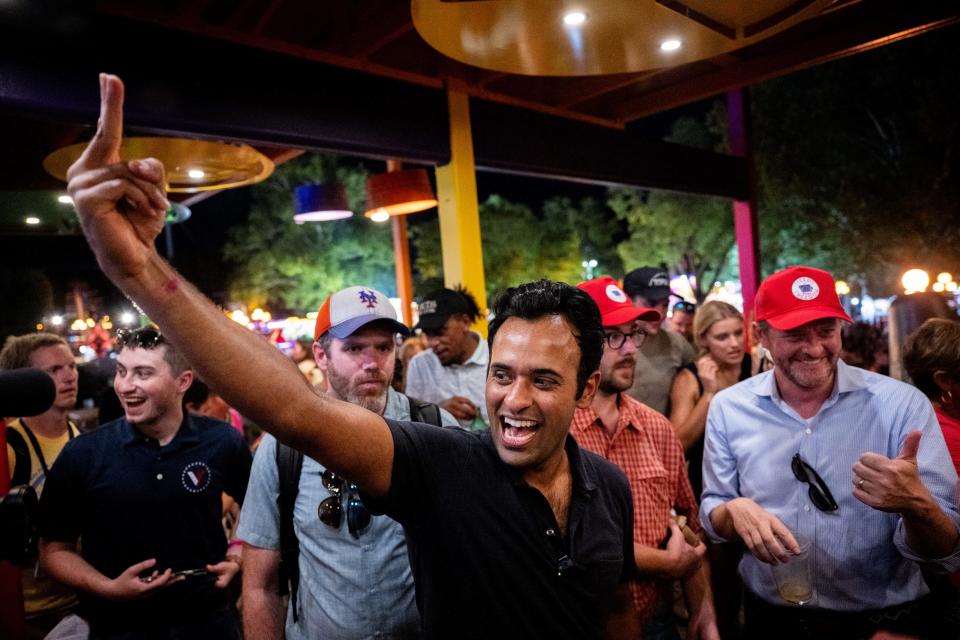 Vivek Ramaswamy cheers with supporters at the Jalapeno Pete's bar at the Iowa State Fair.