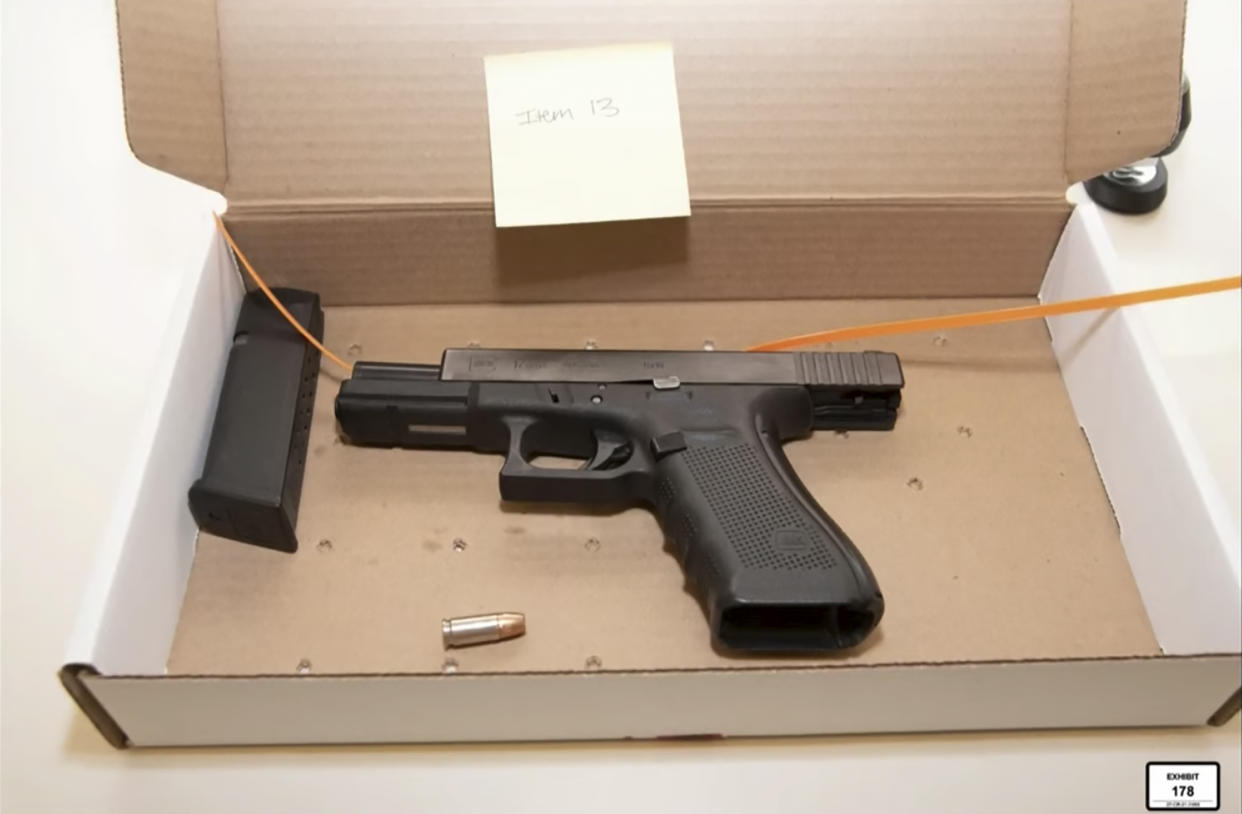 In this screen grab from video, a photo of a Glock 9mm handgun carried by Brooklyn Center police Officer Kim Potter is entered into evidence as Hennepin County Judge Regina Chu presides over court Monday, Dec. 13, 2021, in the trial of Potter in the April 11, 2021, death of Daunte Wright, at the Hennepin County Courthouse in Minneapolis, Minn. (Court TV via AP, Pool)