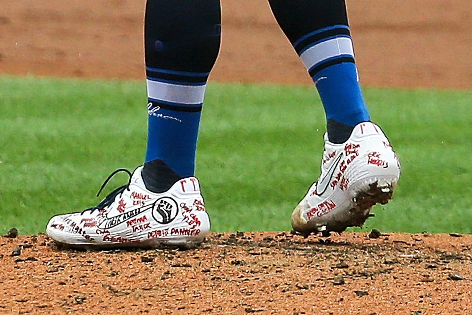 St. Louis Cardinals starting pitcher Jack Flaherty (22) wears cleats supporting the Black Lives Matter movement during the first inning of a baseball game against the Cleveland Indians, Saturday, Aug. 29, 2020, in St. Louis. (AP Photo/Scott Kane)