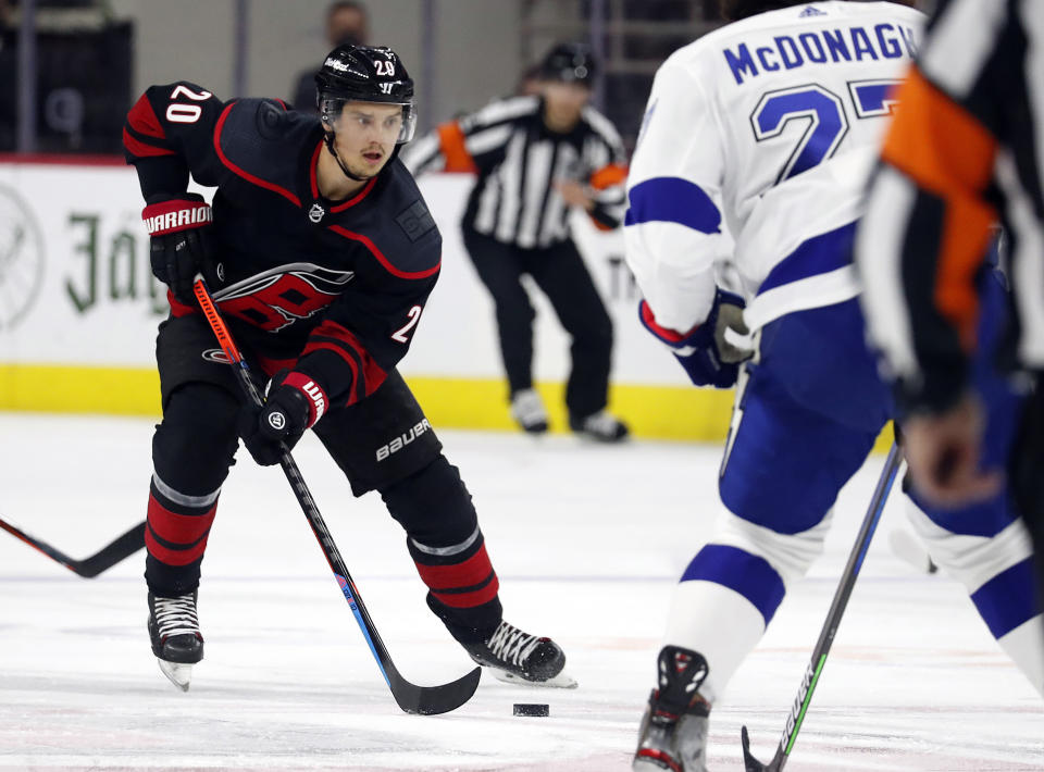 FILE - In this June 1, 2021, file photo, Carolina Hurricanes' Sebastian Aho (20) brings the puck upice against the Tampa Bay Lightning during the second period of Game 2 of an NHL hockey Stanley Cup second-round playoff series in Raleigh, N.C. The Hurricanes have been to the playoffs for three straight years and are hoping offseason changes help them make an even deeper run this season. (AP Photo/Karl B DeBlaker, File)