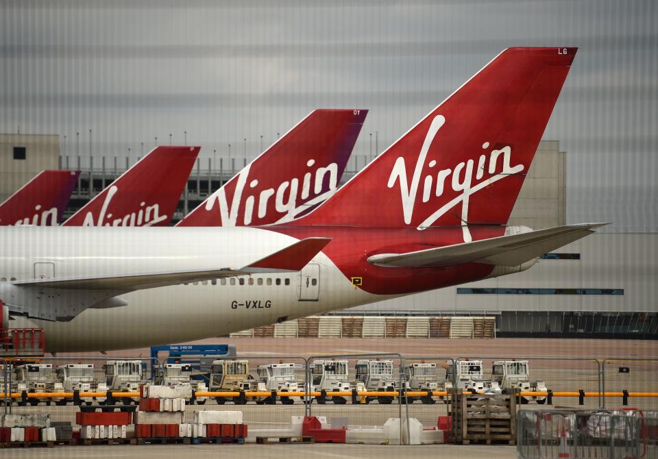 Virgin Atlantic Airline planes are pictured at the apron at Manchester Airport in north-west England, on June 8, 2020, as the UK government's planned 14-day quarantine for international arrivals to limit the spread of the novel coronavirus begins. (Photo by Oli SCARFF / AFP) (Photo by OLI SCARFF/AFP via Getty Images)