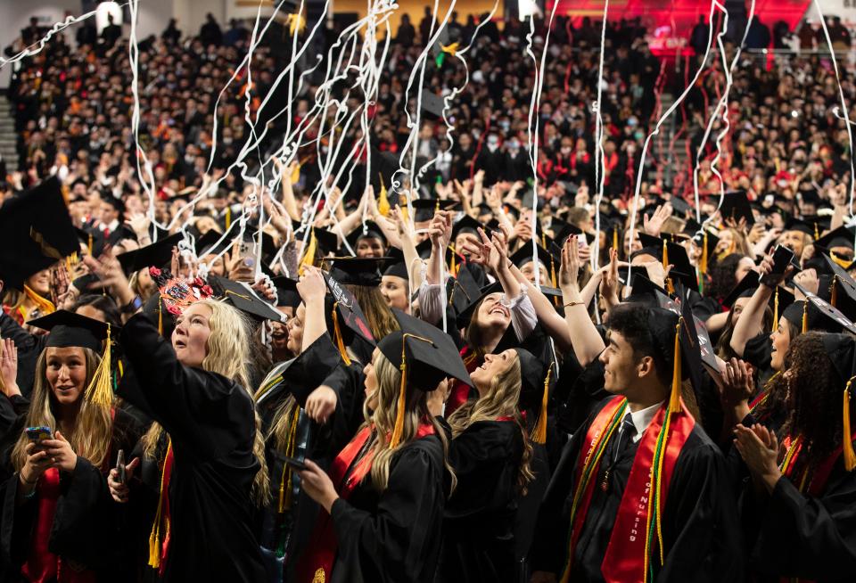 University of Cincinnati graduates participate in graduation at Fifth Third Arena, Friday, April 29, 2022. UC graduated a record 7,080 students over two days at Fifth Third Arena. Streamers fall to conclude the ceremony. 