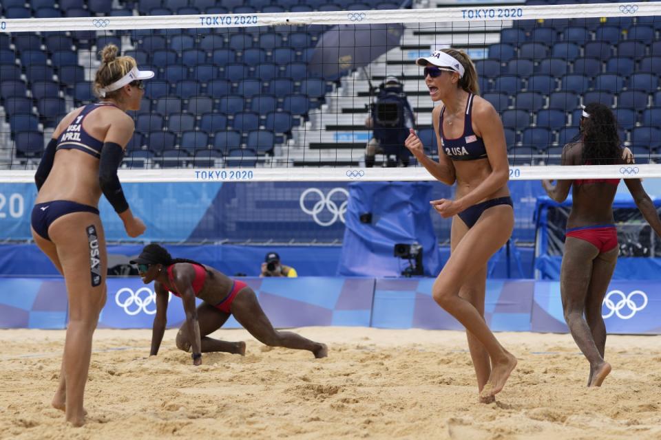 U.S. teammates April Ross, left, and Alix Klineman react after scoring a point against Cuba.