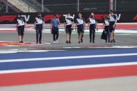 AlphaTauri driver Pierre Gasly, third from left, of France, walks the course with his crew before the Formula One U.S. Grand Prix auto race at the Circuit of the Americas, Thursday, Oct. 21, 2021, in Austin, Texas. (AP Photo/Nick Didlick)