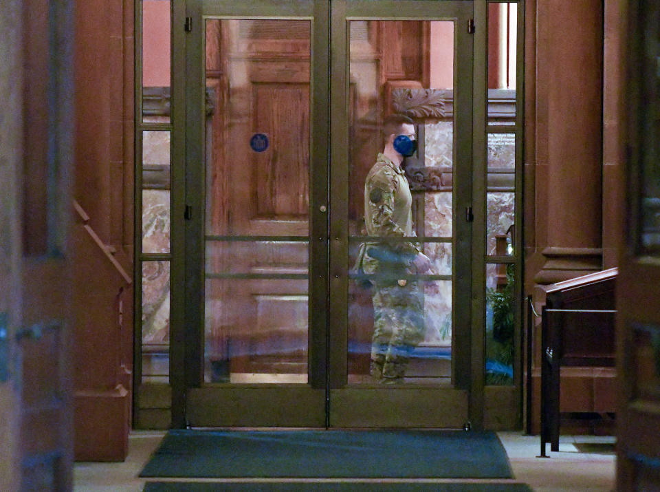 New York state Police wearing tactical gear patrol the hallway outside of Gov. Andrew Cuomo's offices prior to a planned President Trump protest rally ahead of the inauguration of President-elect Joe Biden and Vice President-elect Kamala Harris Sunday, Jan. 17, 2021, in Albany, N.Y. (AP Photo/Hans Pennink)