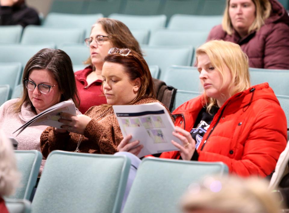 People in attendance look over documents Tuesday, Feb. 7, 2023, at the information session for the South Bend school district’s long-range facilities master plan at Edison Intermediate Center in South Bend.