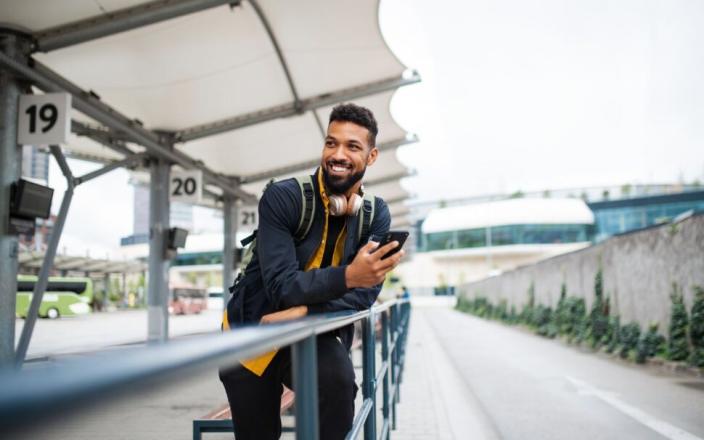 Man standing at bus stop - top first-time solo travel destinations