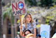 A young protester is seen taking part in The Global Strike 4 Climate rally in Brisbane