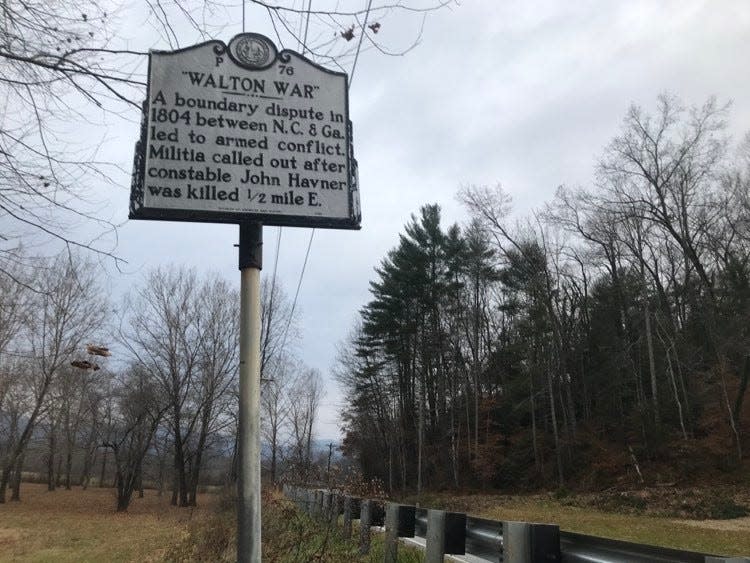 A sign on a street in Brevard, NC educates drivers on the history of the Walton War.