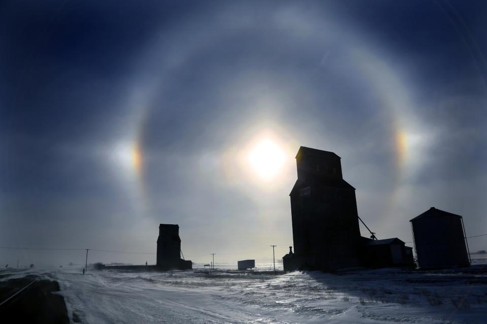 ELIMINATE NDBIS101 OF JAN. 5, 2014 THE PHOTO CARRIES A ST. PAUL PIONEER PRESS RESTRICTION - With temperatures at about 22 below zero with a -50 windchill, it was hard to find the beauty in the brutal weather in Bismarck, N.D., Sunday, Jan. 5, 2014. Sundogs, a ring of light visible around the sun or moon when light is refracted through ice crystals in the atmosphere, are quite beautiful along Highway 83 north of Bismark ND. (AP Photo/The Star Tribune, Brian Peterson) MANDATORY CREDIT; ST. PAUL PIONEER PRESS OUT; MAGS OUT; TWIN CITIES TV OUT MBO