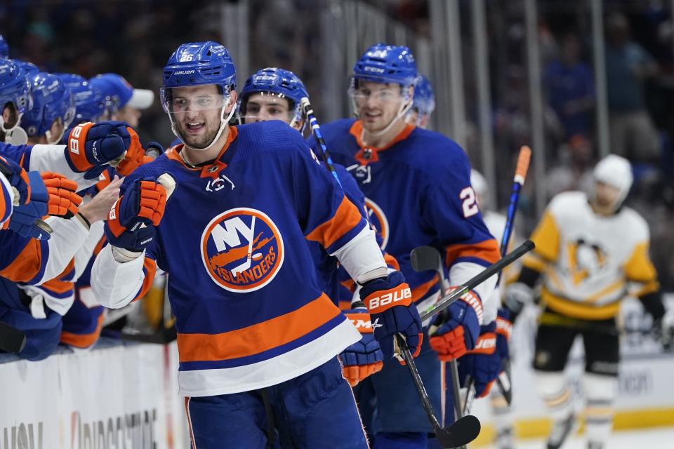 New York Islanders' Oliver Wahlstrom (26) celebrates with teammates after scoring a goal during the third period of Game 4 of an NHL hockey Stanley Cup first-round playoff series against the Pittsburgh Penguins, Saturday, May 22, 2021, in Uniondale, N.Y. The Islanders won 4-1. (AP Photo/Frank Franklin II)