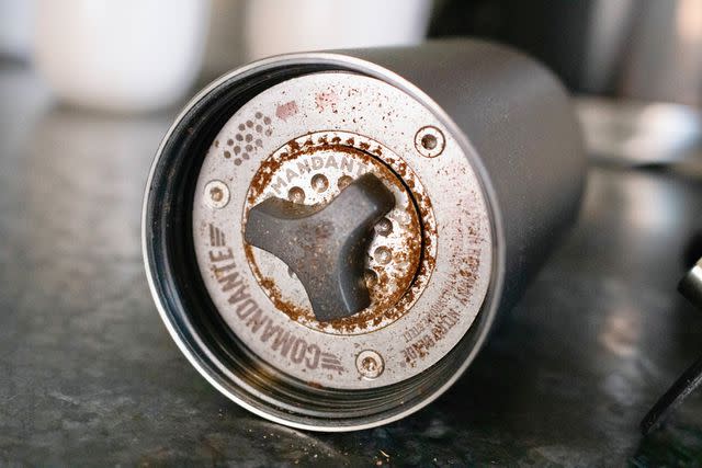 <p>Serious Eats / Jesse Raub</p> Almost every grinder featured a manual click wheel adjustment on the underside of the burrs, but our three favorites had clear illustrations indicating which direction was coarser or finer.