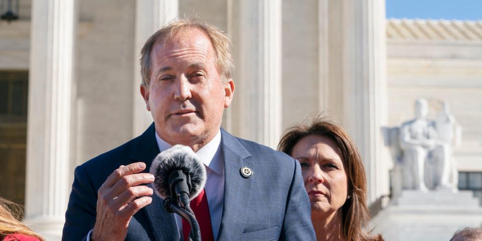 Texas Attorney General Ken Paxton, left, next to his wife and Texas State Sen. Angela Paxton, speaks to anti-abortion activists at a rally outside the Supreme Court, Monday, Nov. 1, 2021