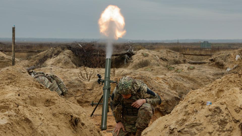 Ukrainian soldiers fire a mortar