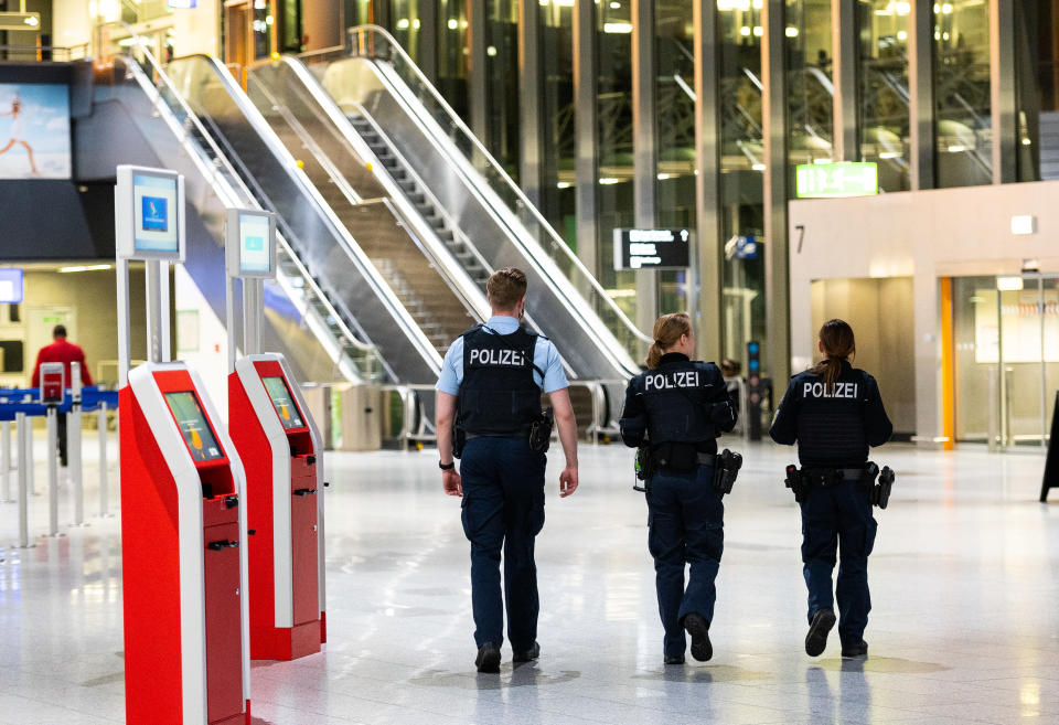 17 March 2020, Hessen, Frankfurt/Main: Three policemen walk through Terminal 1 at the airport. The spokesman for the federal police at the airport has announced an immediate entry ban for non-EU citizens at German airports due to the corona crisis. This regulation will be implemented on Tuesday evening. Photo: Andreas Arnold/dpa (Photo by Andreas Arnold/picture alliance via Getty Images)