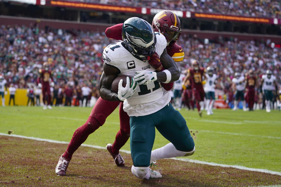 Philadelphia Eagles wide receiver A.J. Brown (11) scoring a touchdown against Washington Commanders cornerback Benjamin St-Juste (25) during the first half of an NFL football game, Sunday, Oct. 29, 2023, in Landover, Md. (AP Photo/Alex Brandon)