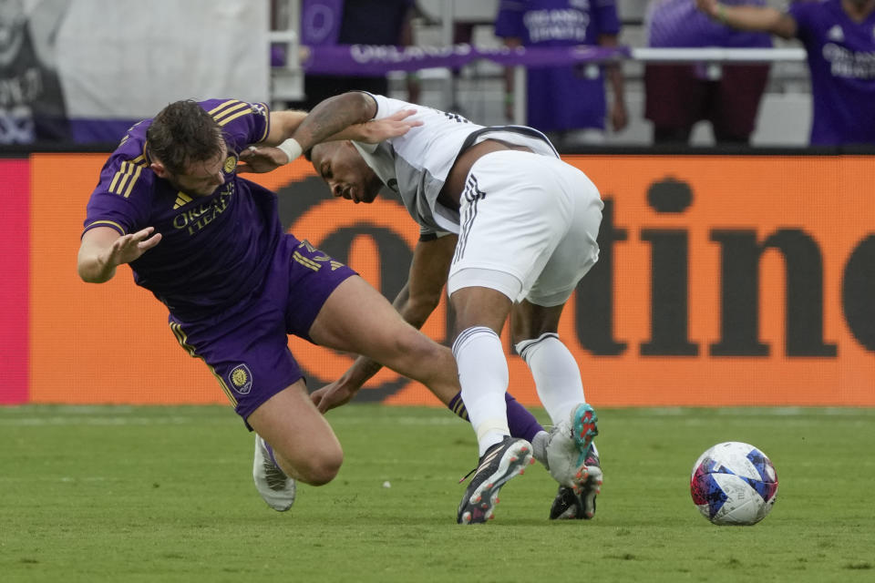 Orlando City forward Duncan McGuire, left, collides with Toronto FC midfielder Mark-Anthony Kaye during the first half of an MLS soccer match Tuesday, July 4, 2023, in Orlando, Fla. (AP Photo/John Raoux)