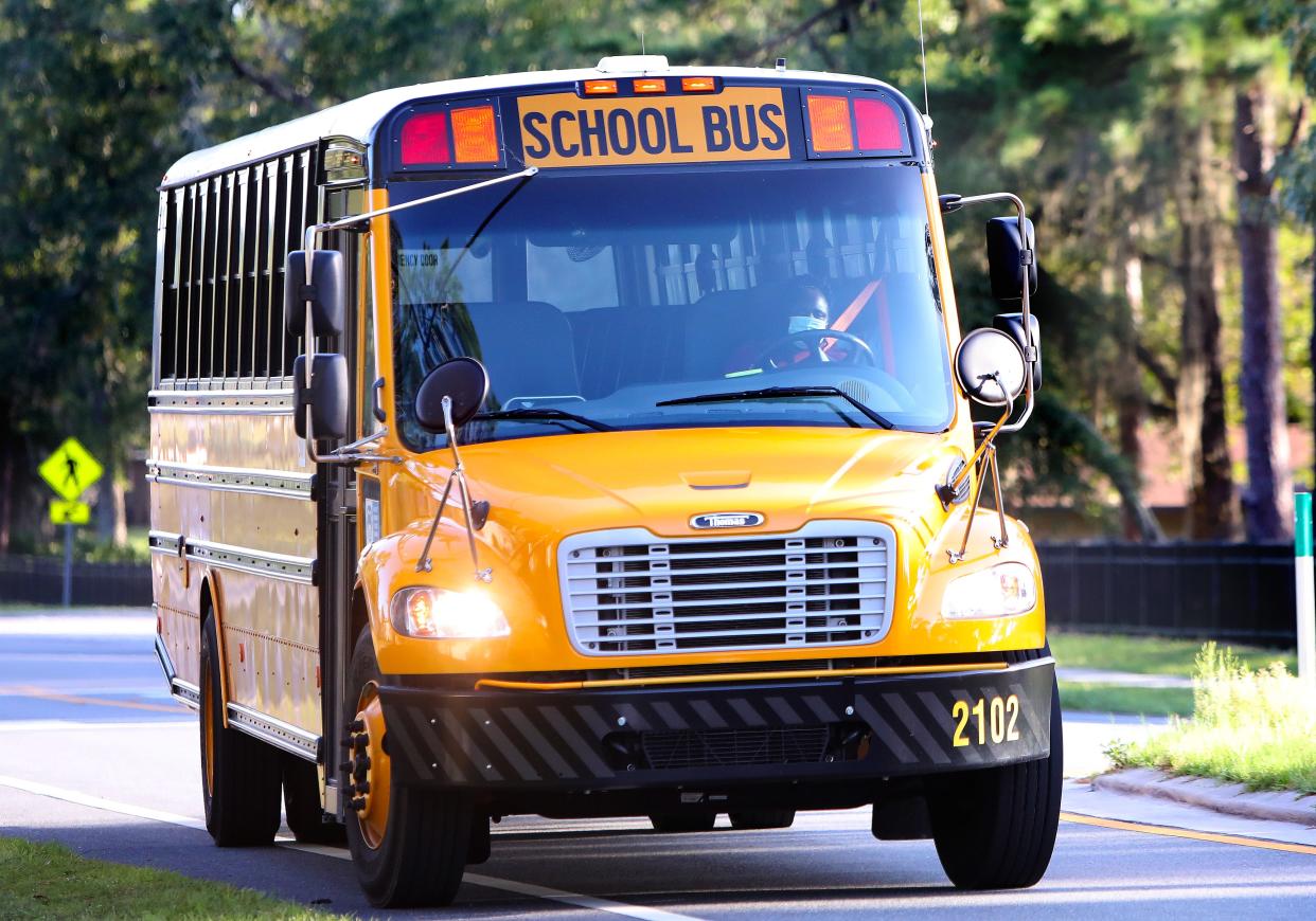 An Alachua County Public Schools bus driver turns a bus out of Eastside High School in Gainesville Fla. Aug. 24, 2021.
