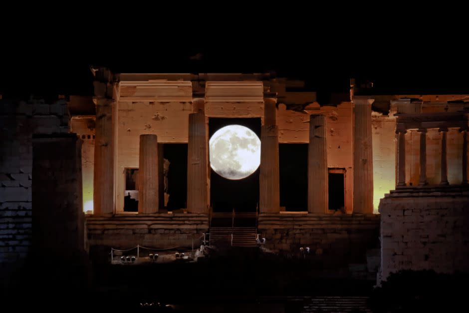 A rising "supermoon" is seen through the Propylaea, the ancient Acropolis hill gateway, in Athens, Greece November 14, 2016.