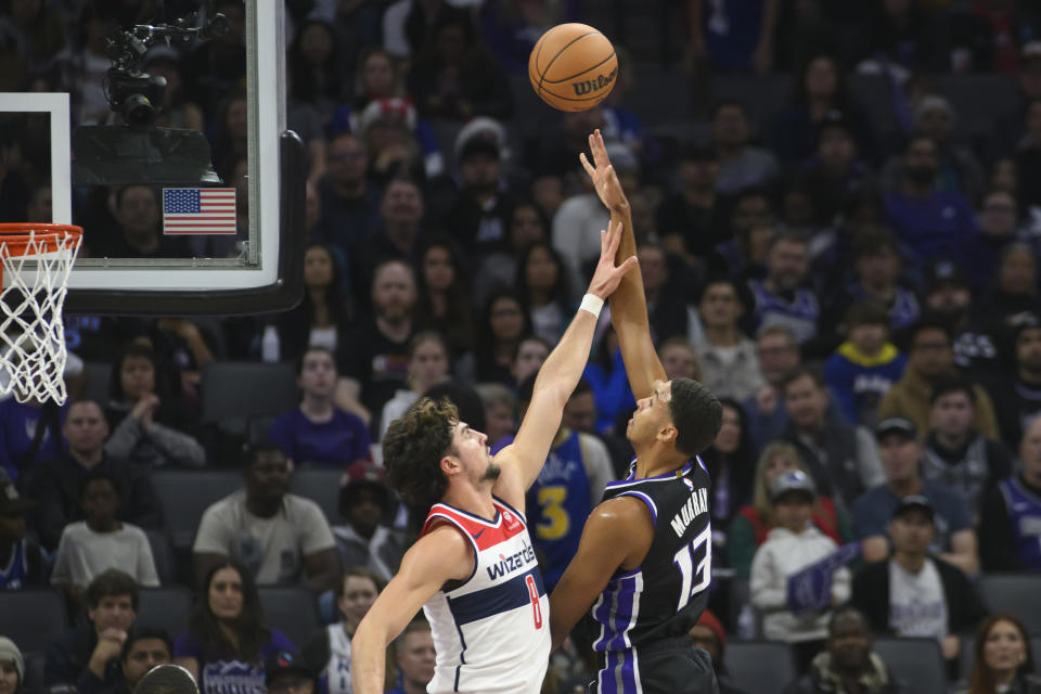 Sacramento Kings forward Keegan Murray (13) shoots over Washington Wizards forward Deni Avdija (8) during the first quarter of an NBA basketball game in Sacramento, Calif., Monday, Dec. 18, 2023. (AP Photo/Randall Benton)