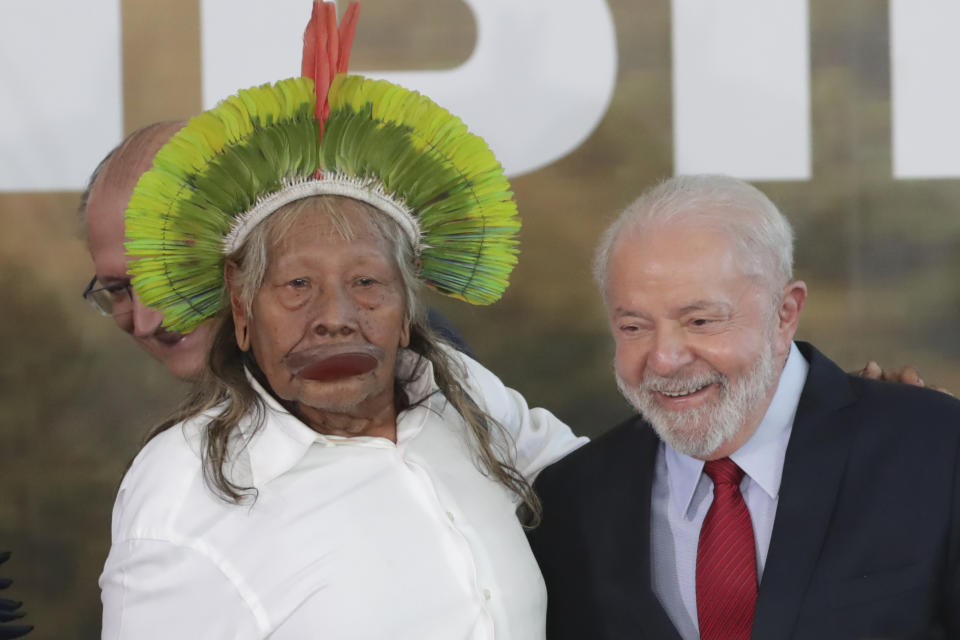 Brazilian President Luiz Inacio Lula da Silva, right, poses for pictures with Indigenous Chief Raoni Metuktire during an event where Lula announced measures to prevent and control deforestation in the Amazon region on World Environment Day in Brasilia, Brazil, Monday, June 5, 2023. (AP Photo/Gustavo Moreno)