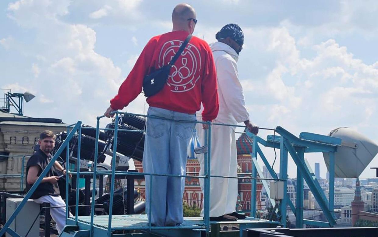 Kanye West (right) pictured in the centre of Moscow