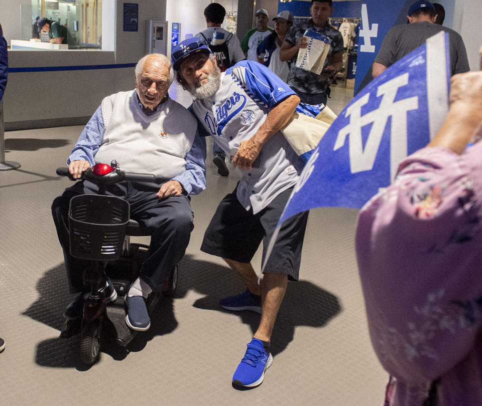 Hall of Fame and former Los Angeles Dodgers manager Tommy Lasorda passed away at the age of 93. 91 year-old Hall of Fame and former Los Angeles Dodgers manager Tommy Lasorda, left, poses for pictures outside of the Vin Scully Press Box prior to a MLB baseball game between the Los Angeles Dodgers and the San Francisco Giants at Dodger Stadium on Thursday, June 20, 2019 in Los Angeles, California. (Keith Birmingham/The Orange County Register via AP)