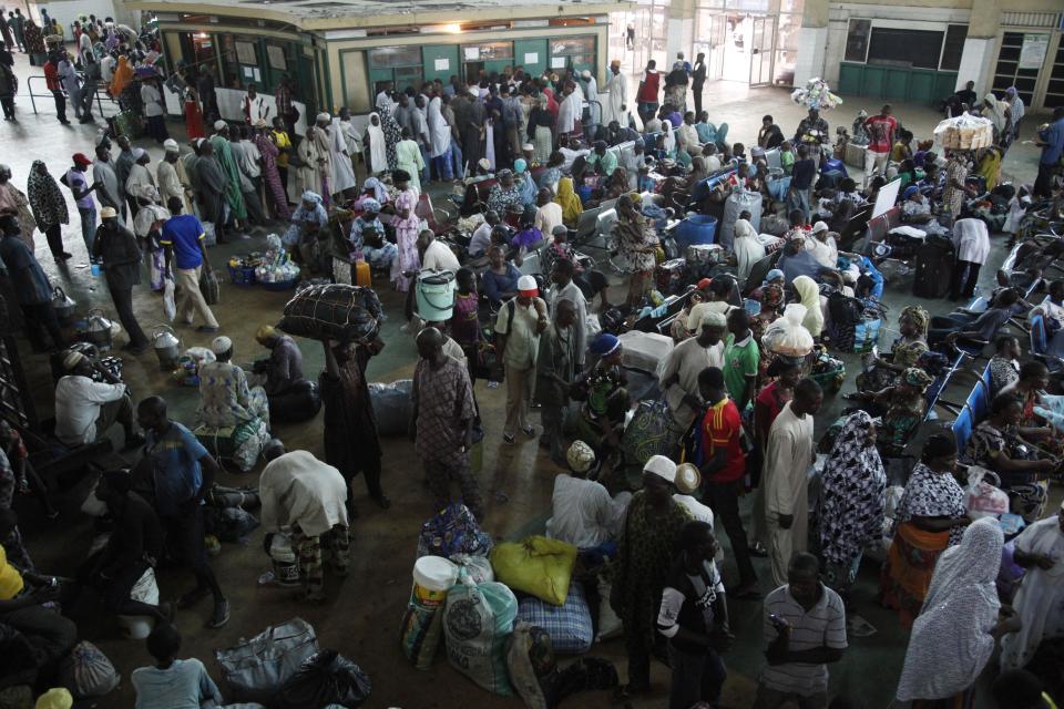In this Photo taken, Friday, March . 15, 2013, passengers lineup to purchased train ticket to Kano, in a terminal in Lagos, Nigeria. Nigeria reopened its train line to the north Dec. 21, marking the end of a $166 million project to rebuild portions of the abandoned line washed out years earlier. The state-owned China Civil Engineering Construction Corp. rebuilt the southern portion of the line, while a Nigerian company handled the rest. ( AP Photo/Sunday Alamba)